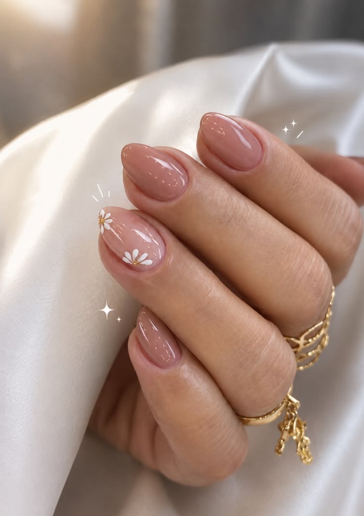 Effet nude lumineux avec une fleur minimaliste sur un ongle